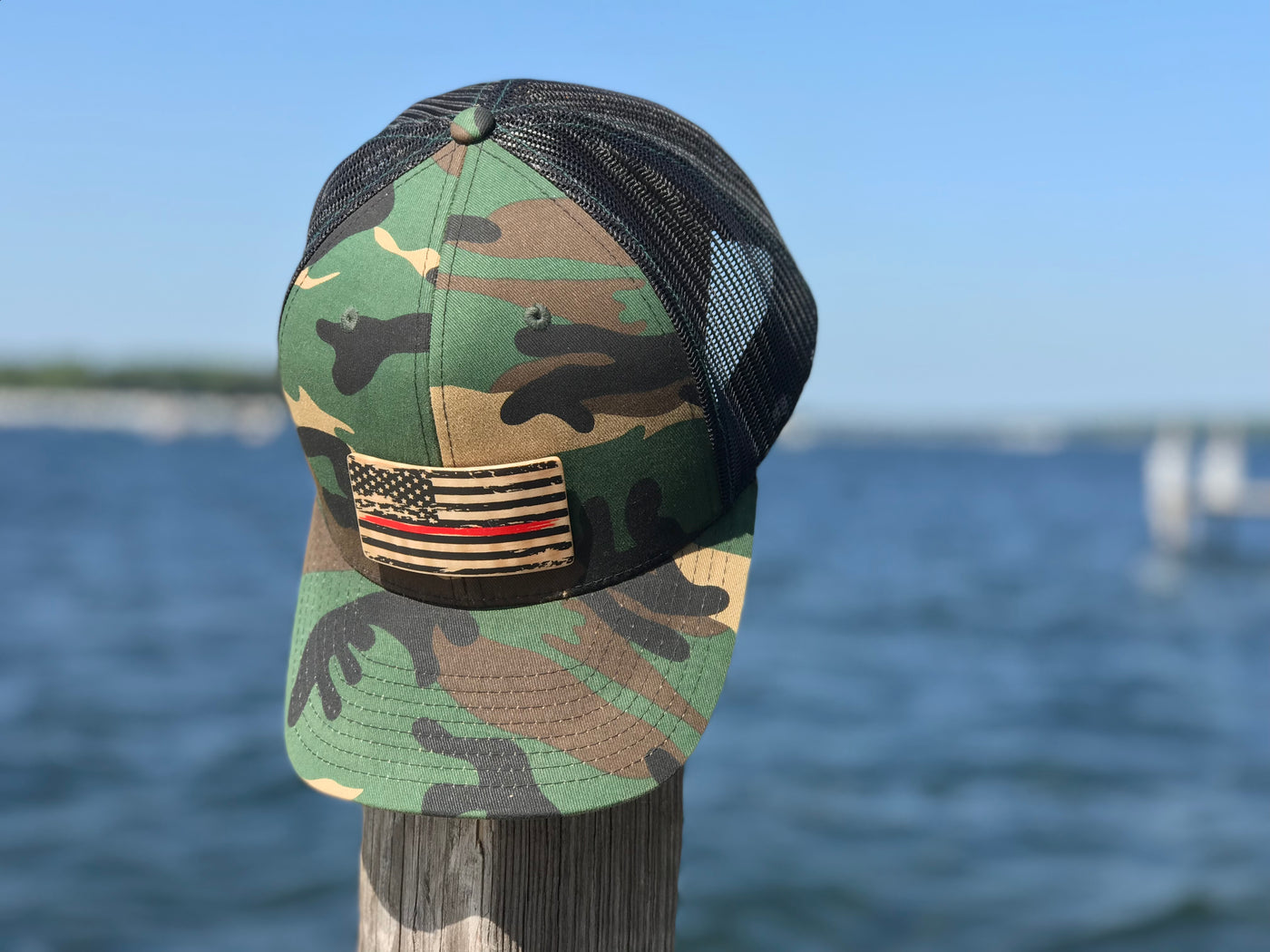 Camo true North hat with a wooden American flag plank